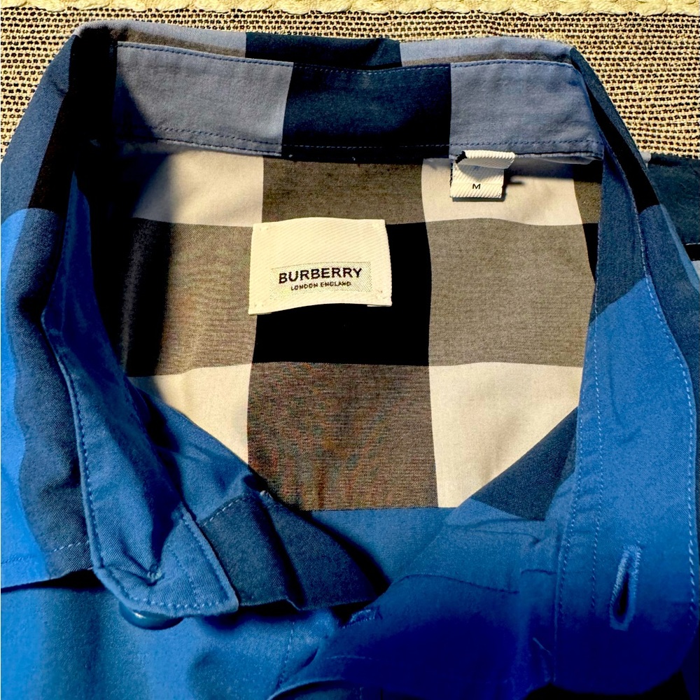 Burberry London.  Never worn.  Dry cleaned once.